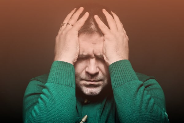 Мужчина держится за голову